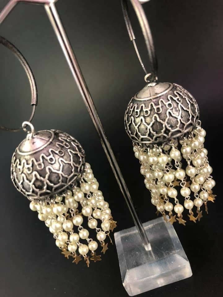 Pearl Star Jhumka Earrings: Carved Metal Drop Earrings
