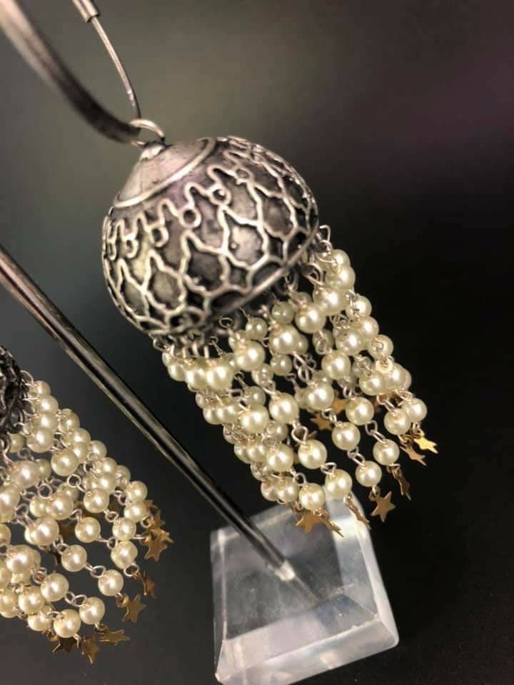 Pearl Star Jhumka Earrings: Carved Metal Drop Earrings