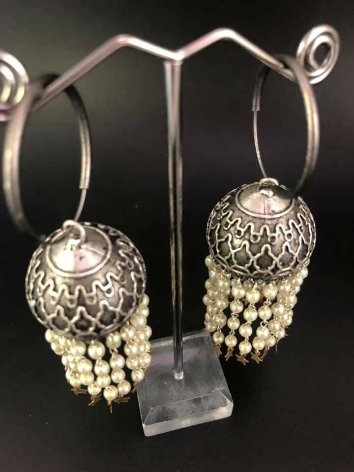 Pearl Star Jhumka Earrings: Carved Metal Drop Earrings