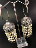 Pearl Star Jhumka Earrings: Carved Metal Drop Earrings